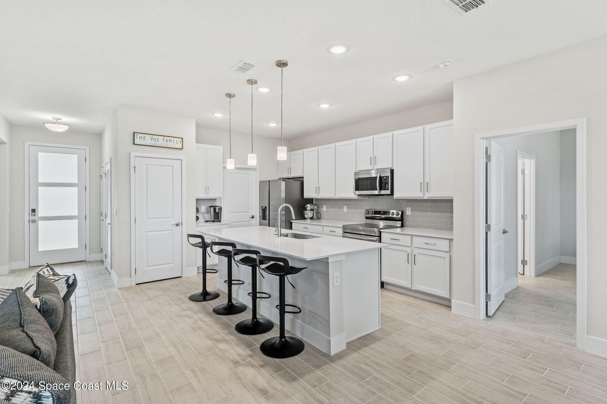 355 Wendover Road Southwest Palm Bay, FL 32908 - Photo 9 of 44 a kitchen with white cabinets and sink