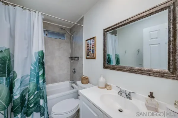 a bathroom with a sink toilet and mirror