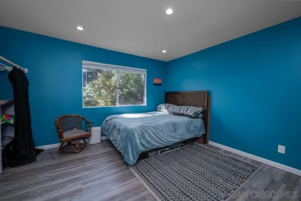 a bedroom with a bed chair and a window