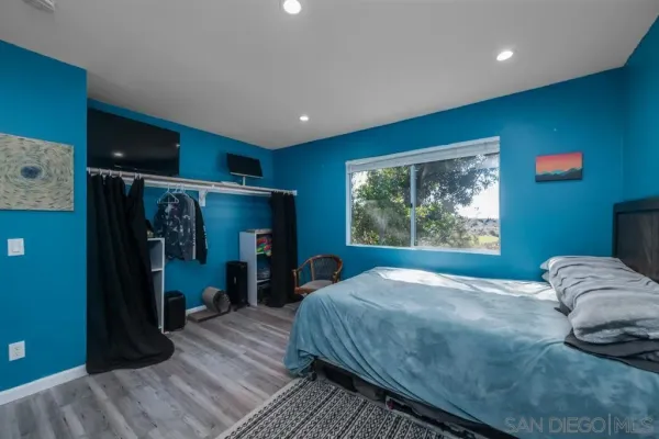 a bed sitting in a room next to a window