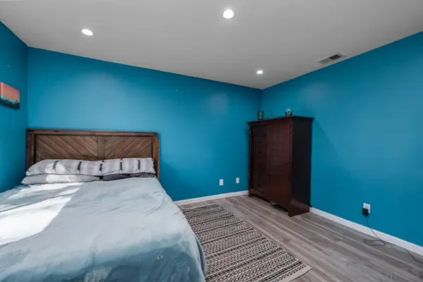 a bedroom with a bed and a potted plant