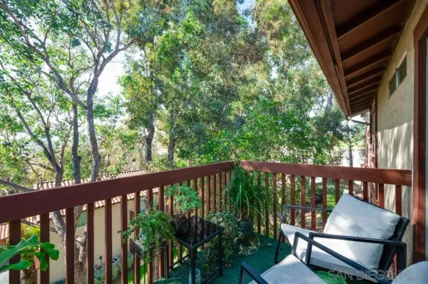 a view of a balcony with wooden floor
