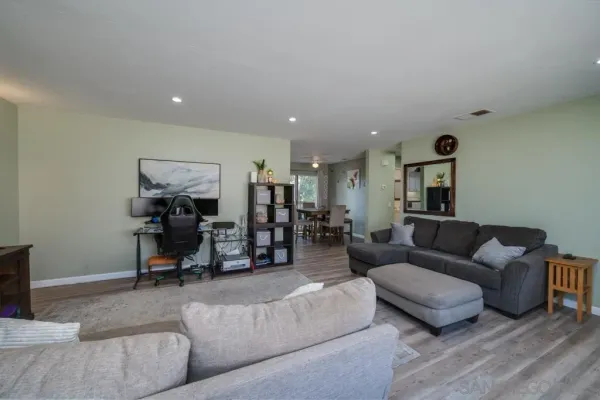 a living room with furniture and a mirror