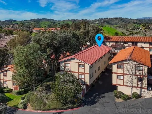 an aerial view of a house with a yard and lake view