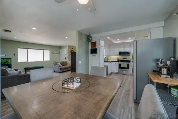 a large kitchen with a table and chairs in it