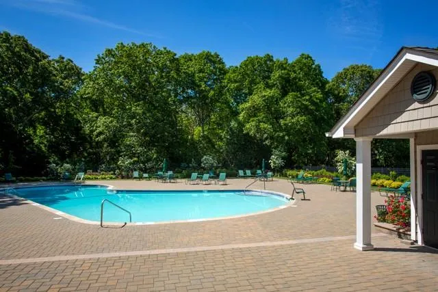 an outdoor space with pool and furniture