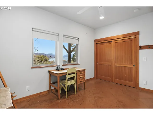 a room with wooden floor and windows