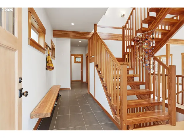 a view of entryway livingroom and hall with wooden floor