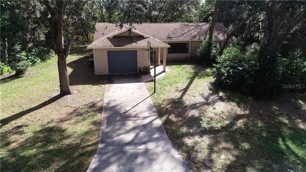 8159 Tranquil Drive Spring Hill, FL 34606 - Photo 1 of 1 a view of a house with a yard