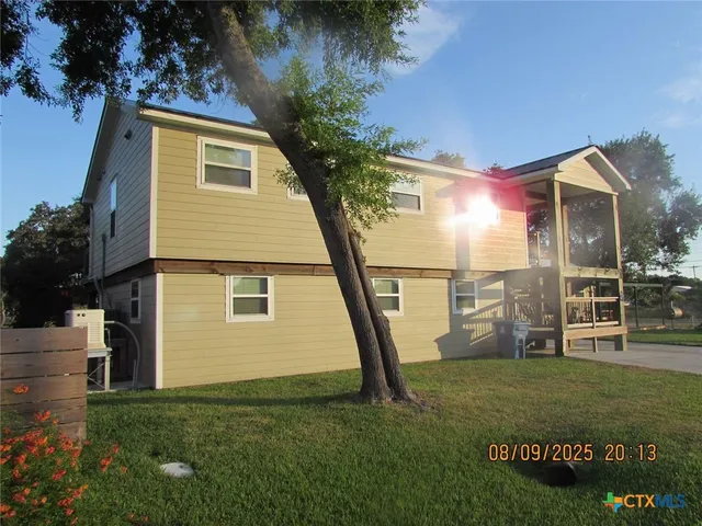 a view of a house with a backyard