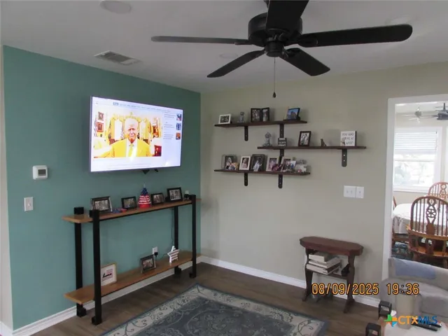 a bedroom with furniture and a wooden floor