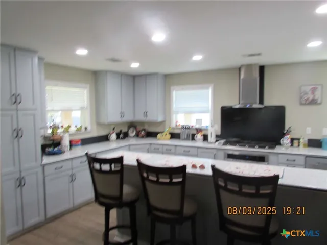 a kitchen with a dining table cabinets and chairs