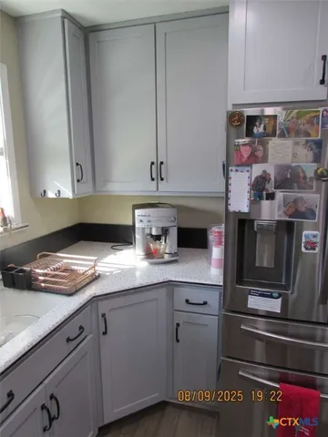 a kitchen with stainless steel appliances granite countertop a sink and a stove