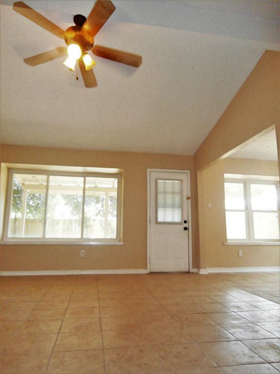 10011 Appleridge Drive Houston, TX 77070 - Photo 11 of 48 a view of an empty room with chandelier fan and a window