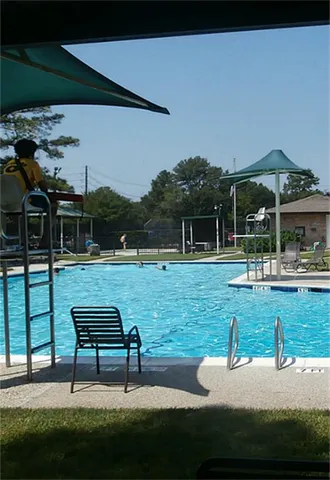 a view of swimming pool with outdoor seating and yard