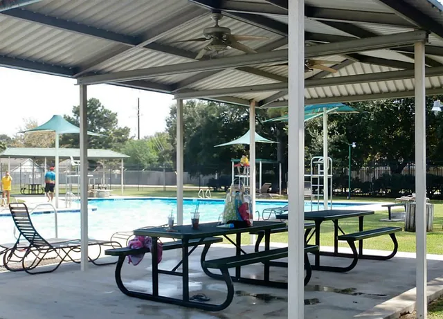 a swimming pool with outdoor seating and yard