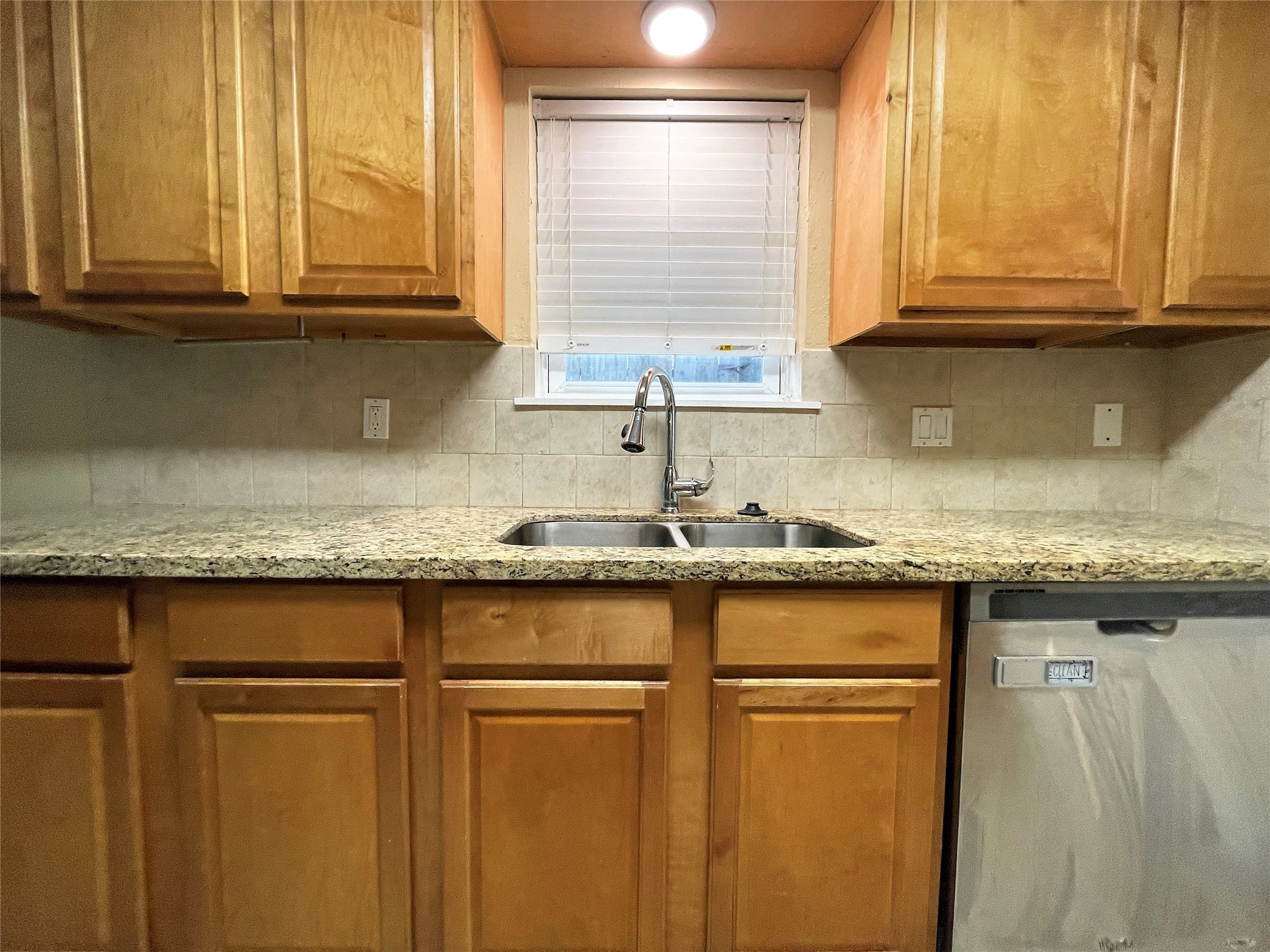 10011 Appleridge Drive Houston, TX 77070 - Photo 5 of 48 a kitchen with granite countertop cabinets stainless steel appliances and a window