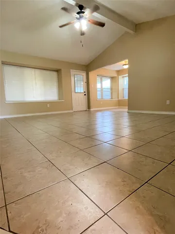 a view of an empty room with glass door