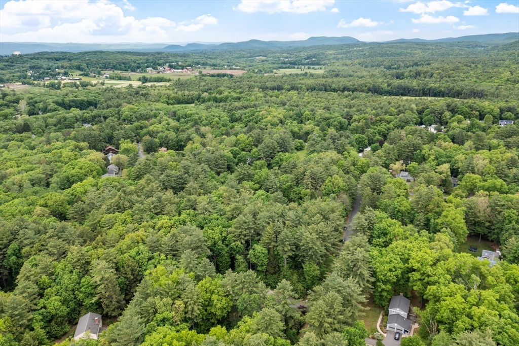 0 Heatherstone Road Amherst, MA 01002 - Photo 3 of 9 a view of a city with lush green forest