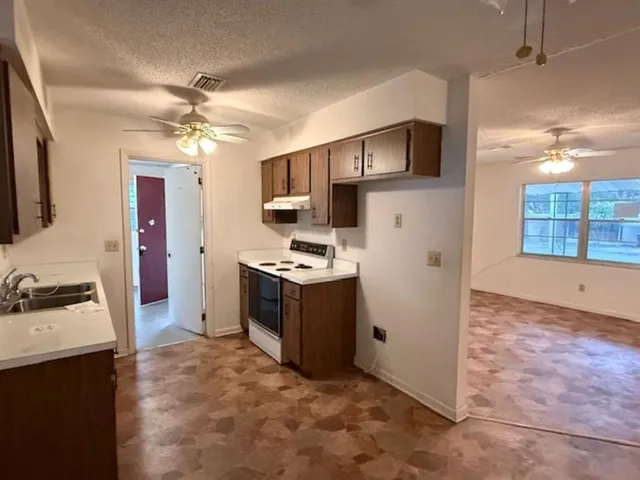 a kitchen with a sink appliances and cabinets