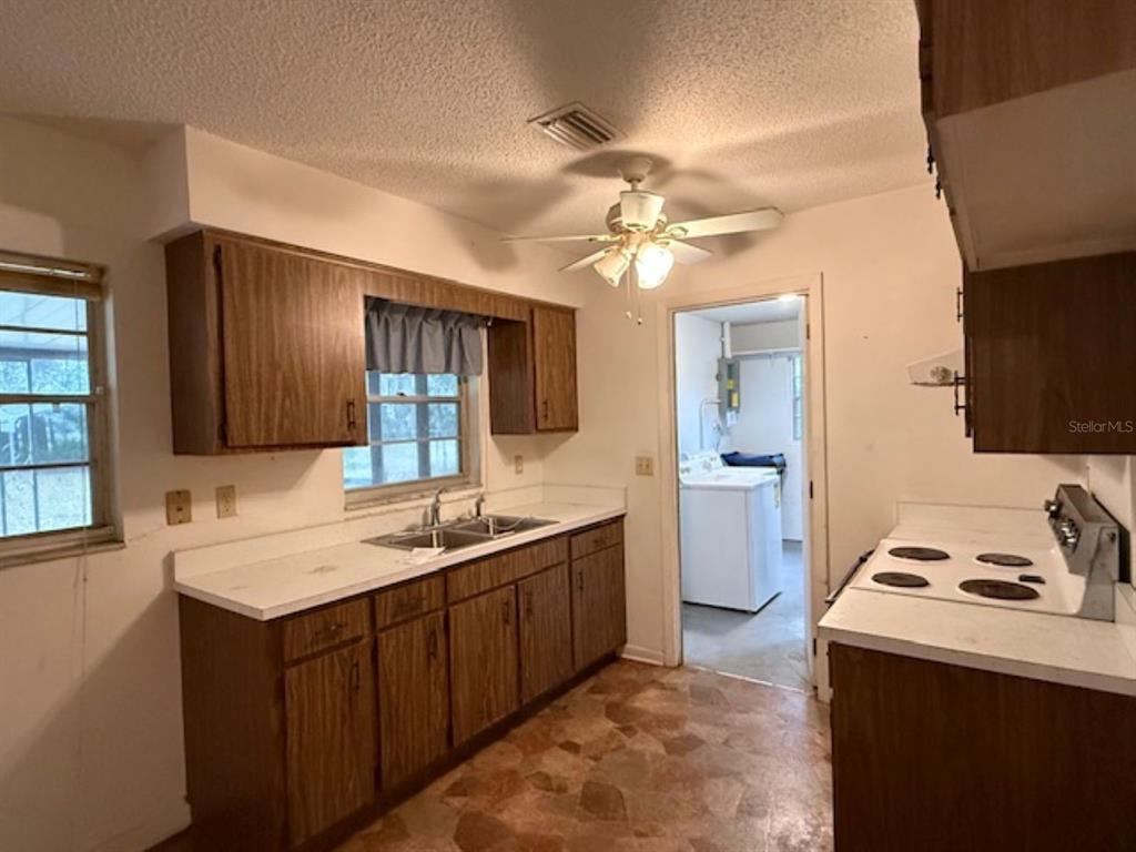 5737 Southeast Babb Road Belleview, FL 34420 - Photo 5 of 11 a kitchen with a sink appliances and cabinets