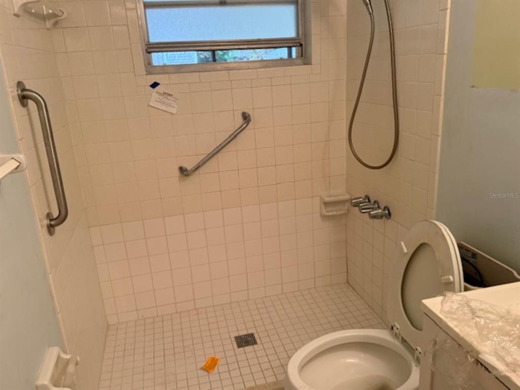 5737 Southeast Babb Road Belleview, FL 34420 - Photo 7 of 11 a bathroom with a granite countertop toilet sink and shower