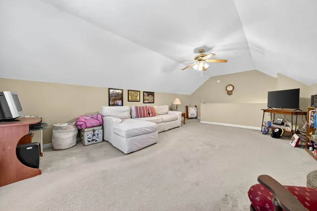 a living room with furniture and a dresser