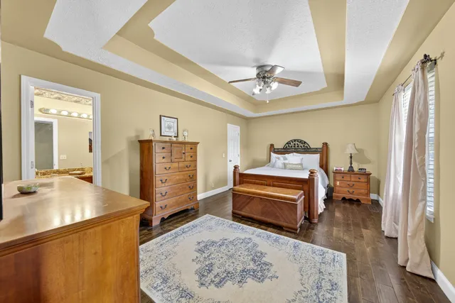 a bathroom with a granite countertop sink toilet and mirror