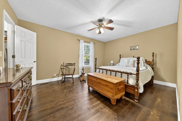 a room with a bed and a ceiling fan