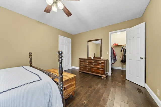 a bathroom with a granite countertop toilet sink and a mirror