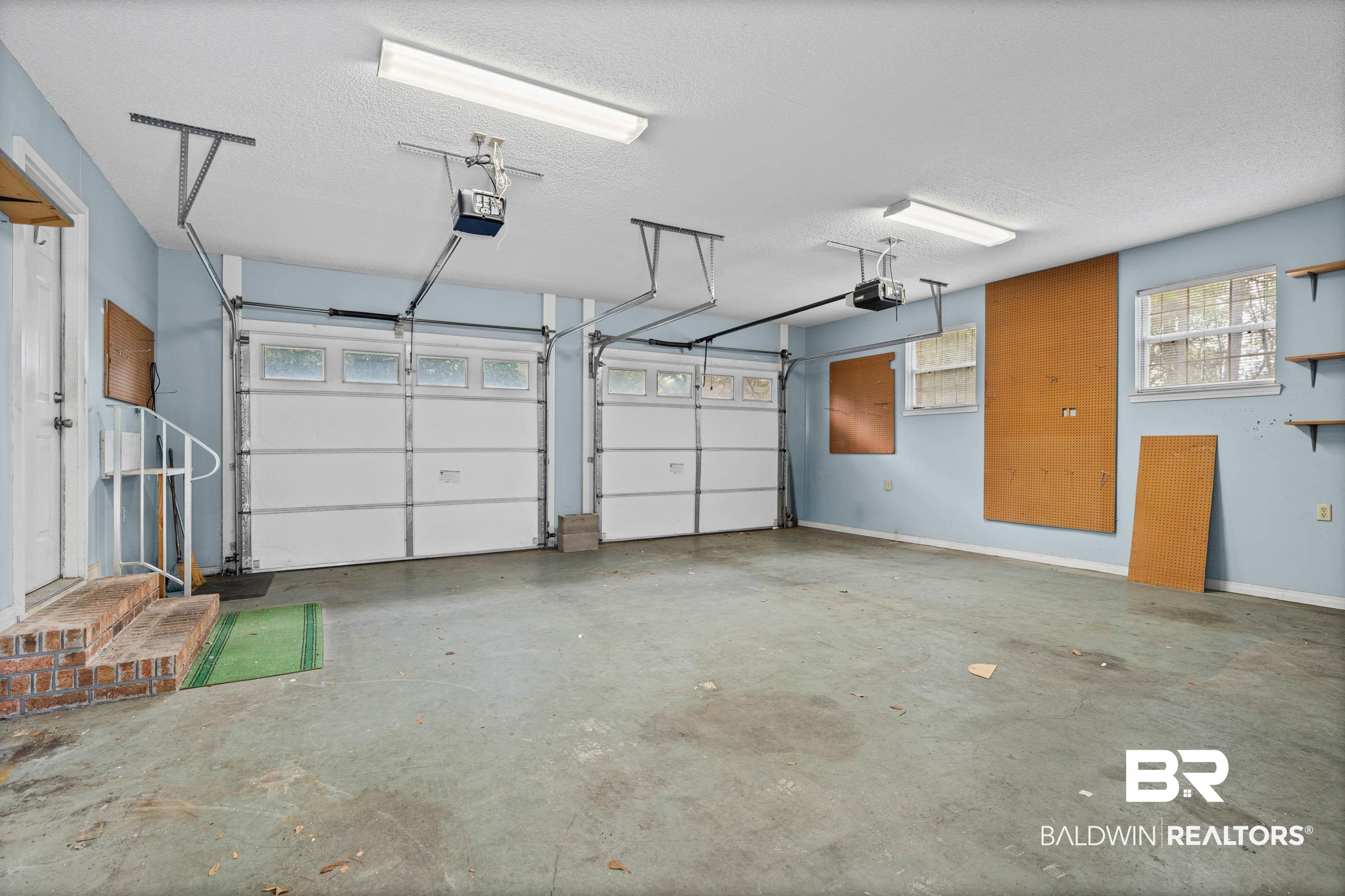 10140 Lakeview Road Bay Minette, AL 36507 - Photo 27 of 35 Garage featuring baseboards and a garage door opener