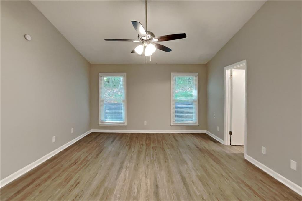 3883 Nowlin Road Kennesaw, GA 30144 - Photo 11 of 21 a view of empty room with wooden floor and fan