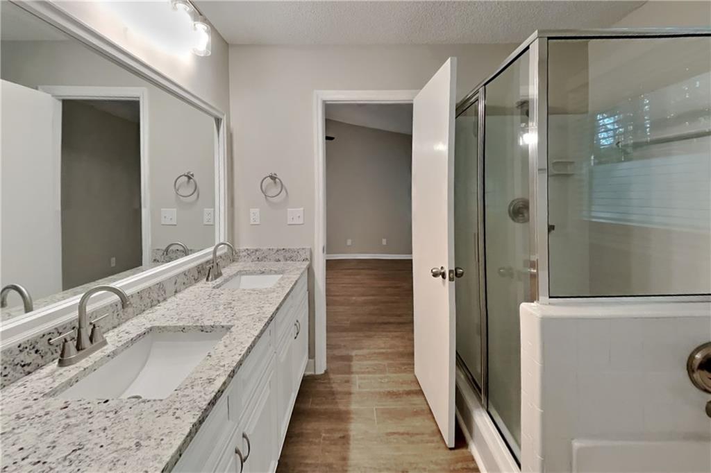3883 Nowlin Road Kennesaw, GA 30144 - Photo 12 of 21 a bathroom with a granite countertop double vanity sink and a mirror