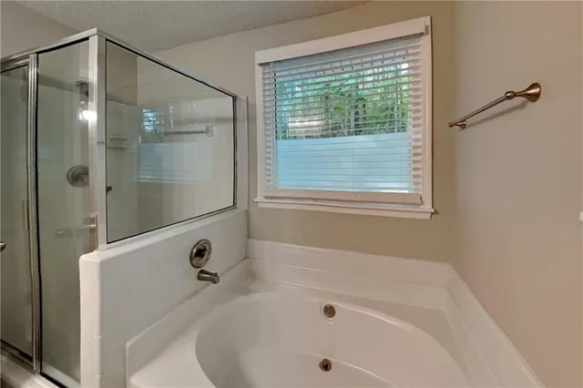 a bathroom with a tub and a shower