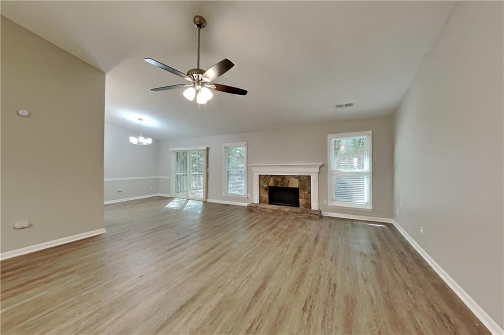 3883 Nowlin Road Kennesaw, GA 30144 - Photo 2 of 21 a view of an empty room with wooden floor and a window