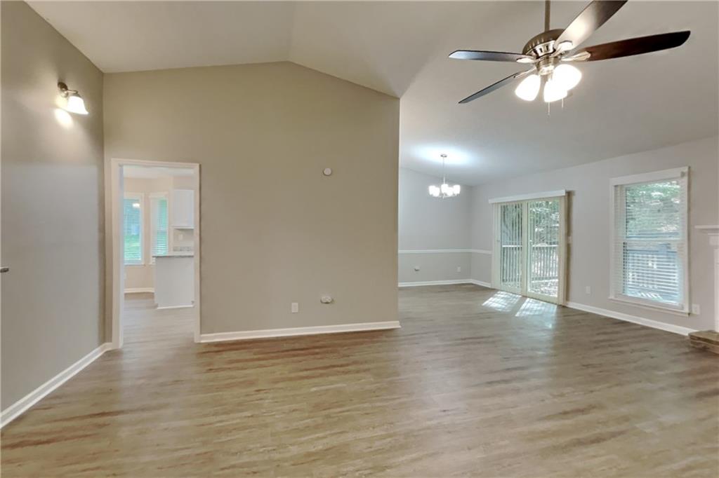 3883 Nowlin Road Kennesaw, GA 30144 - Photo 3 of 21 a view of an empty room with window and wooden floor