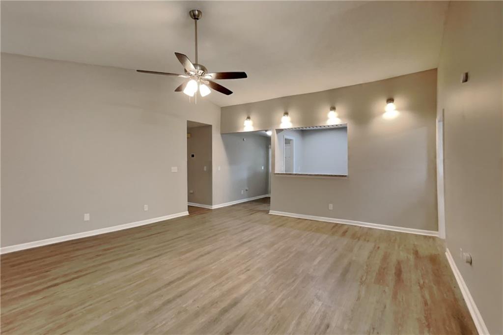 3883 Nowlin Road Kennesaw, GA 30144 - Photo 4 of 21 a view of an empty room with wooden floor and a ceiling fan