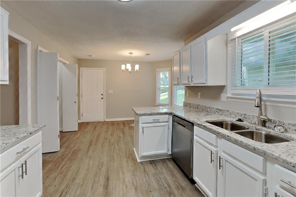 3883 Nowlin Road Kennesaw, GA 30144 - Photo 6 of 21 a kitchen with a sink stove and cabinets