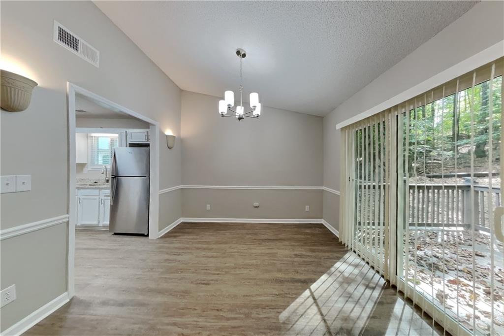 3883 Nowlin Road Kennesaw, GA 30144 - Photo 8 of 21 a view of a livingroom with a chandelier