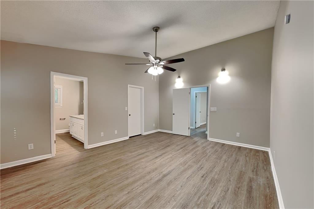 3883 Nowlin Road Kennesaw, GA 30144 - Photo 10 of 21 an empty room with wooden floor and windows