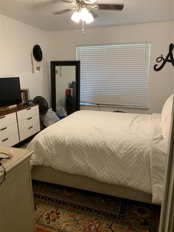 2904 Old Houston Road, Unit 7 Huntsville, TX 77340 - Photo 14 of 19 a bedroom with bed and window