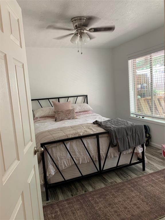 2904 Old Houston Road, Unit 7 Huntsville, TX 77340 - Photo 17 of 19 a bed sitting in a bedroom next to a window