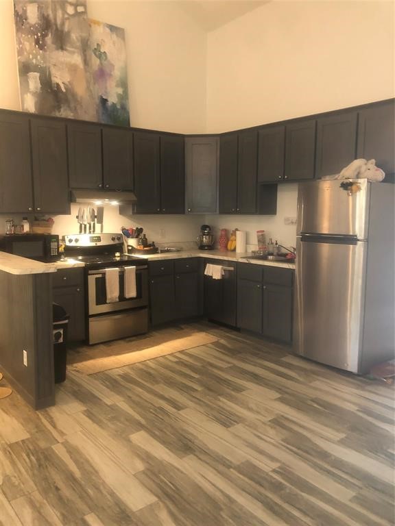 2904 Old Houston Road, Unit 7 Huntsville, TX 77340 - Photo 6 of 19 a kitchen with stainless steel appliances granite countertop a sink stove and refrigerator