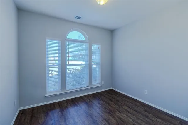 a view of a bedroom with closet and windows