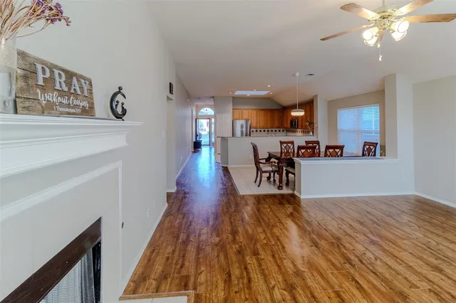 a view of livingroom with hardwood floor and ceiling fan