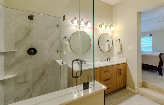 a bathroom with a sink a mirror and shower