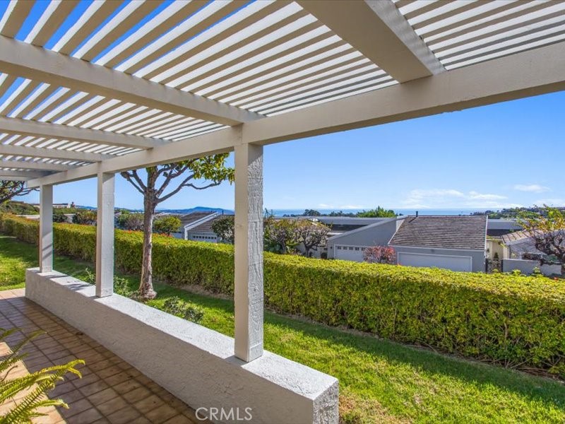 22792 Dominita Road Laguna Niguel, CA 92677 - Photo 37 of 52 a view of a porch with a floor to ceiling window next to a yard