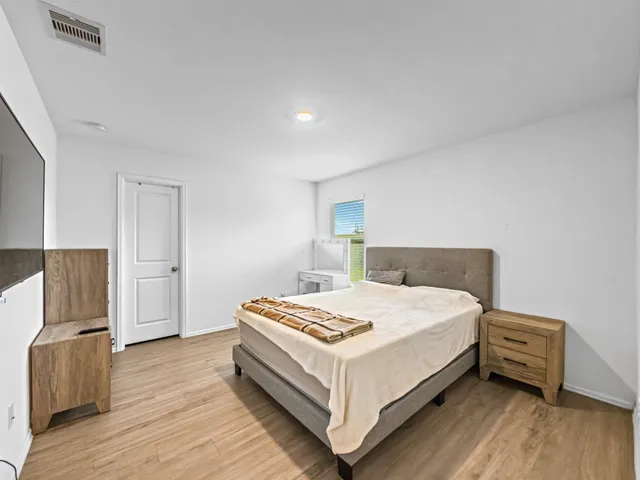 a bed room with a bed and a chair