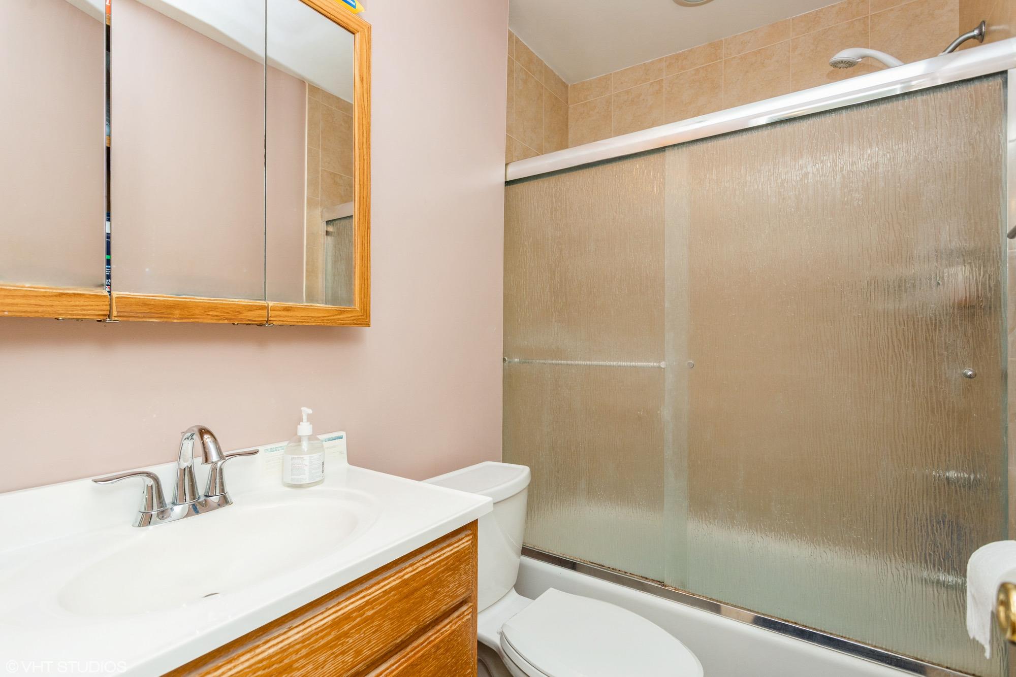15 Sharon Drive Spring Valley, NY 10977 - Photo 14 of 24 Bathroom with toilet, vanity, and shower / bath combination with glass door