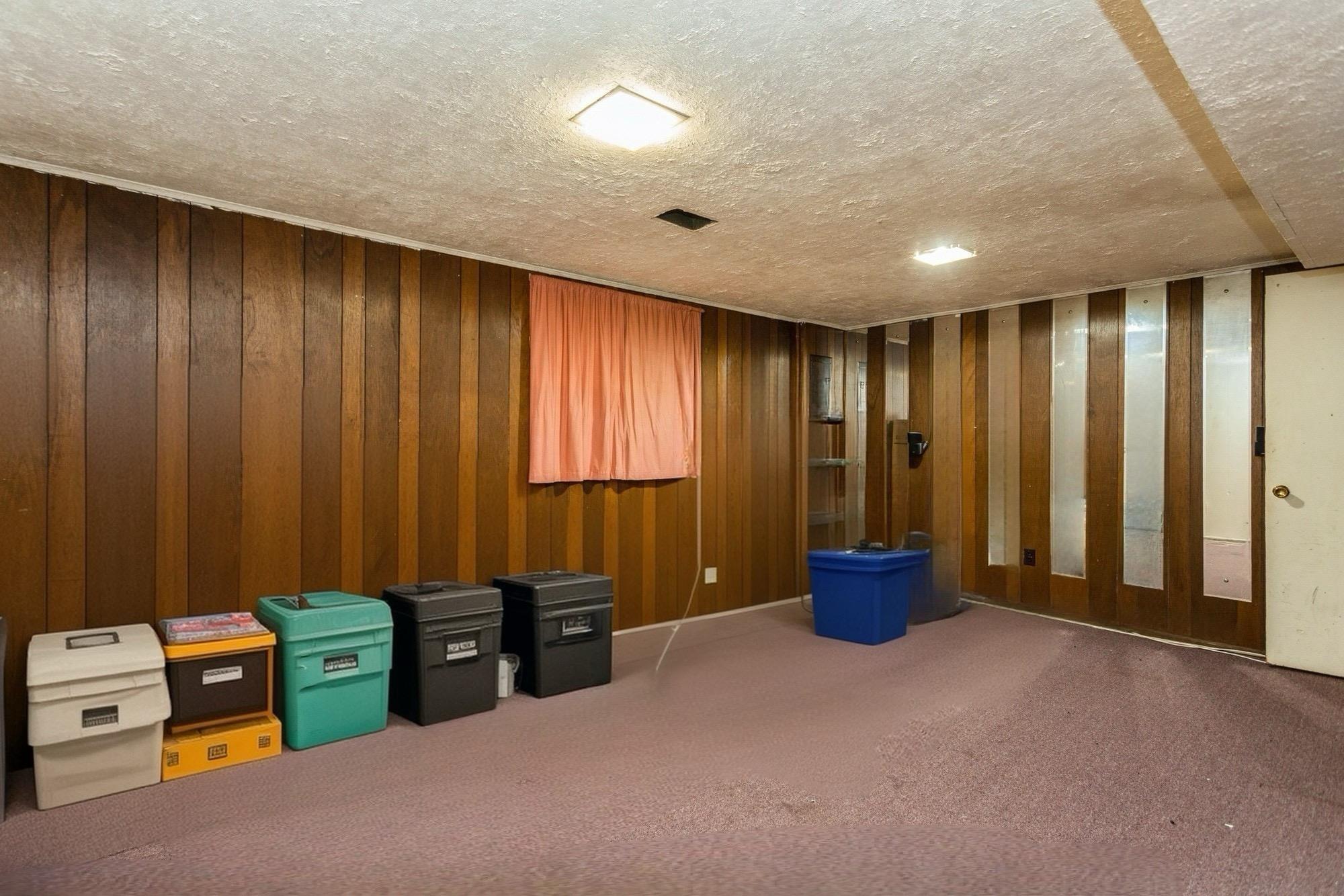 15 Sharon Drive Spring Valley, NY 10977 - Photo 16 of 24 Misc room featuring a textured ceiling, carpet flooring, and wood walls